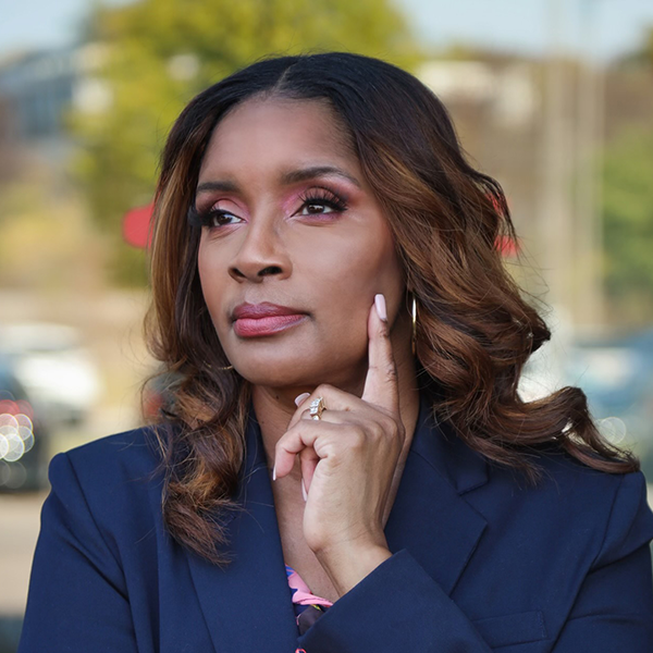 Pastor Stacie Gaines in a blue blazer with a blurred outdoor background.